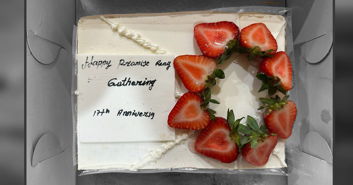 Anniversary cake topped with strawberries and a message celebrating the Promise Ring Gathering 17th anniversary